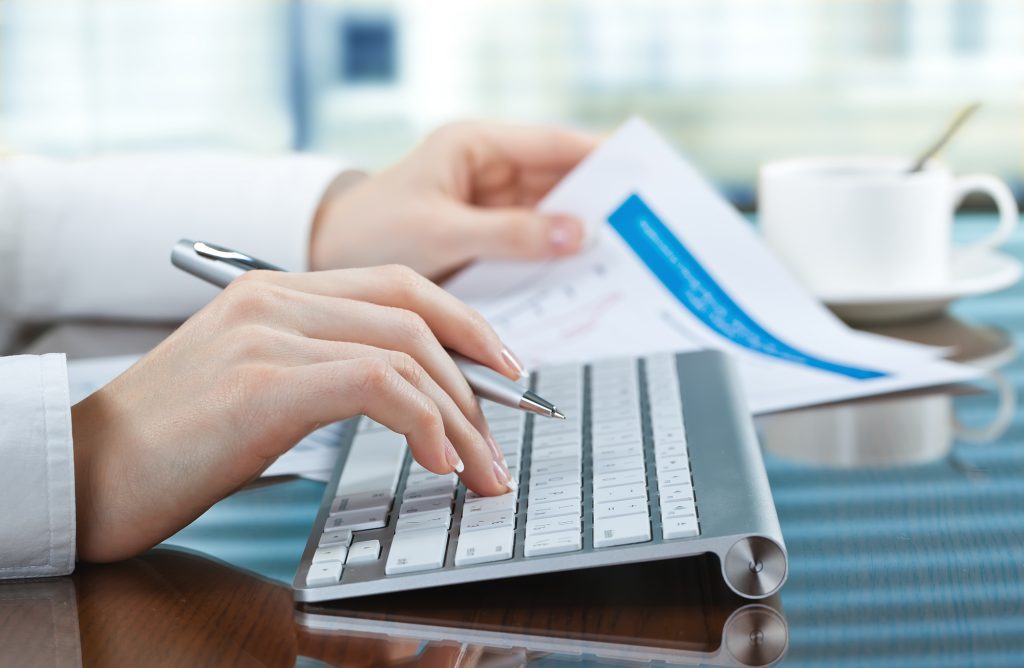 typing on a computer, small business bookkeeping