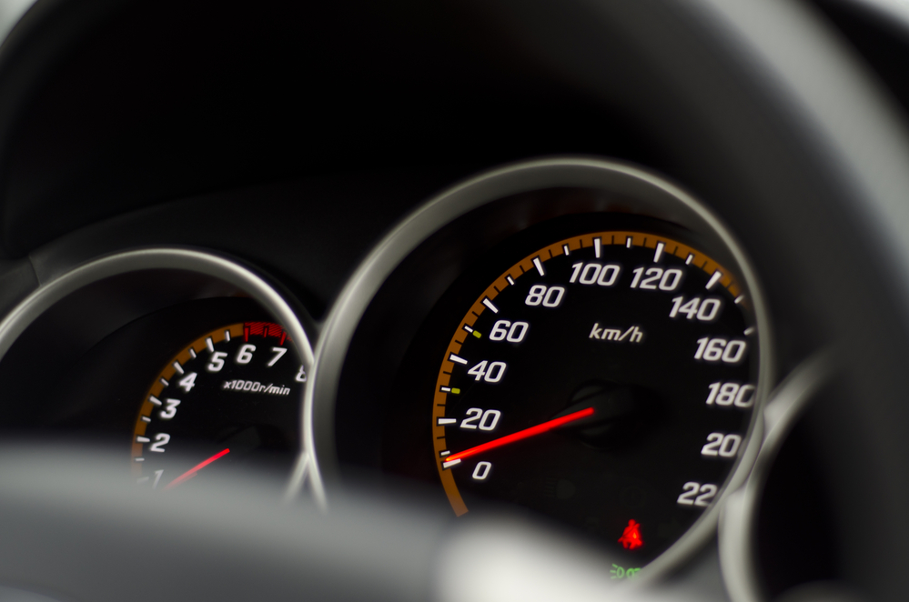 closeup of a speedometer on a car dash, milage rates 2023