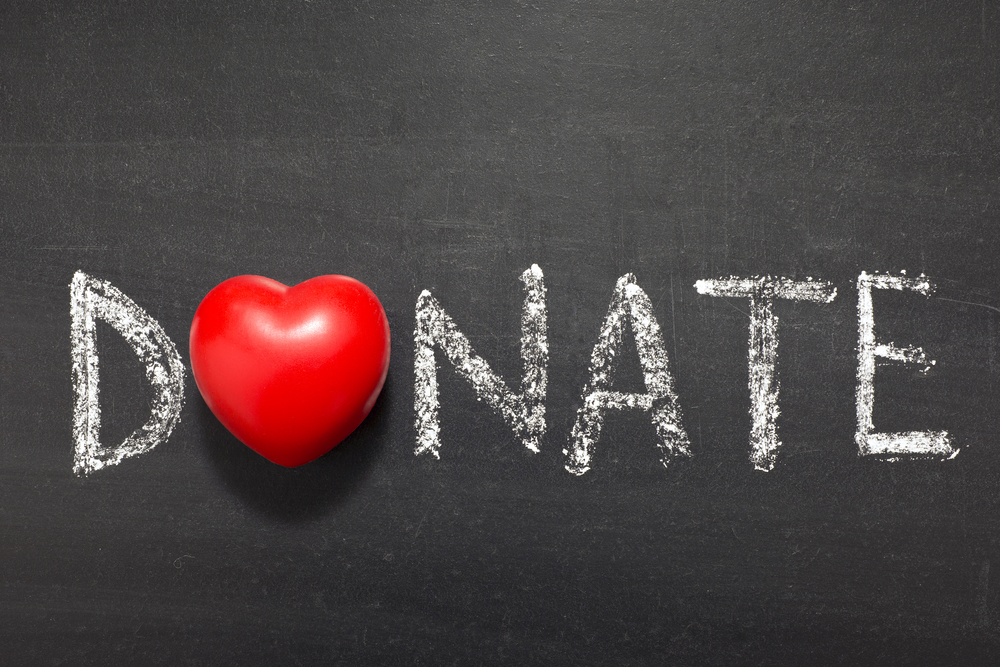 donate written in chalk with the O replaced by a heart, charitable giving